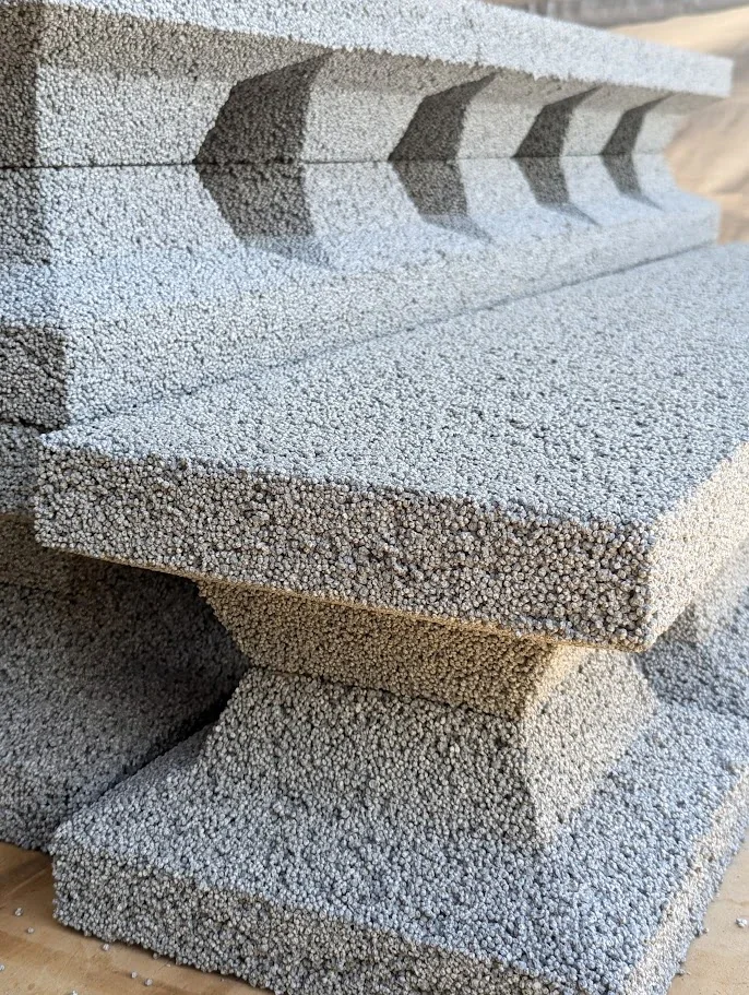 Close-up of stacked Common Blocks, showing foam beads bound in cement and the tapered webs between cores