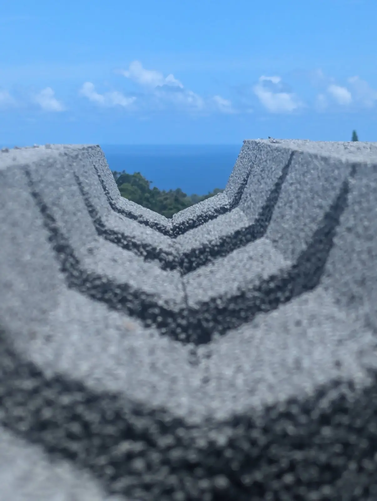 View through the V-shaped top of a block toward the ocean