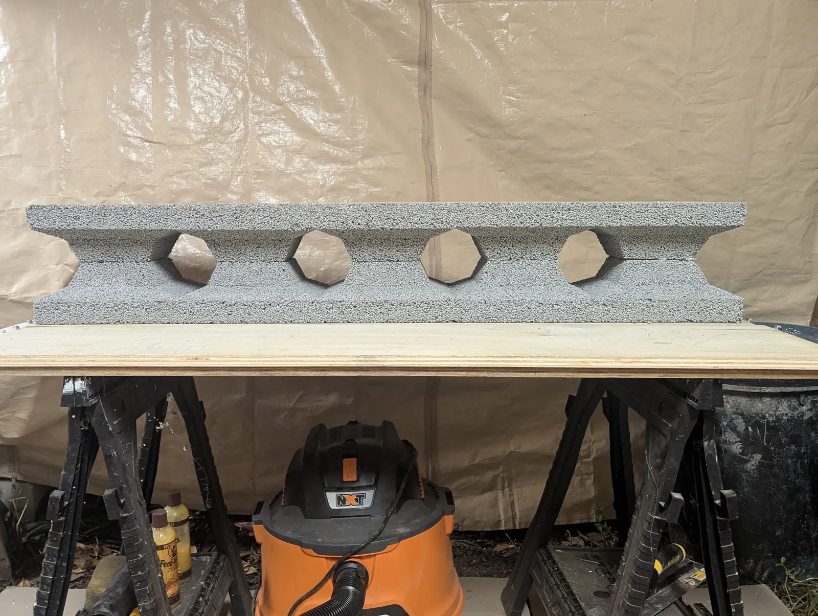 A finished block on sawhorses, hexagonal cores visible