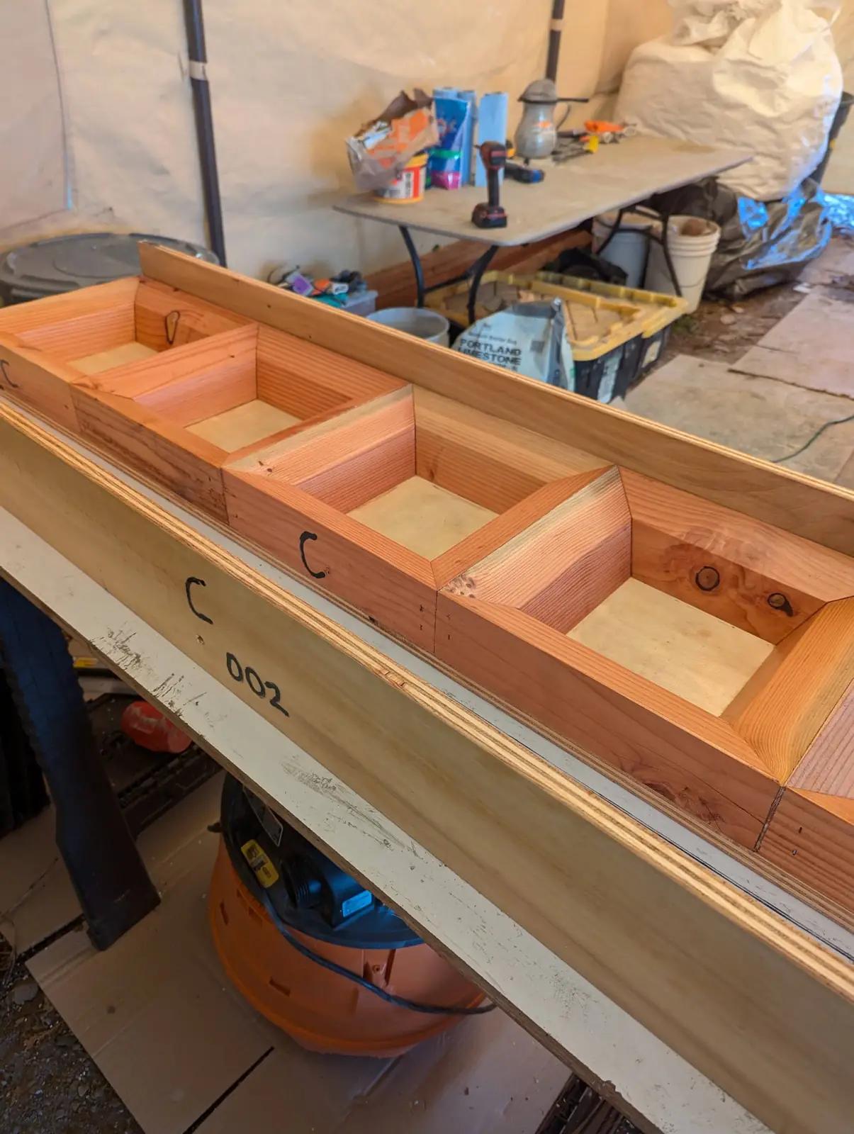 Open mold boxes lined up on a workbench