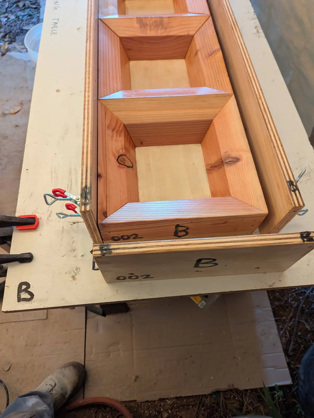 Wooden mold box clamped on a casting table